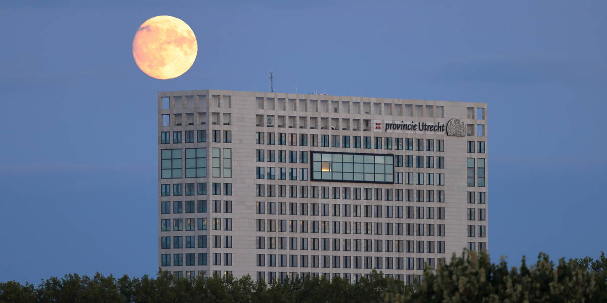 Link naar foto in Flickr: een volle maan boven het Provinciehuis Utrecht.